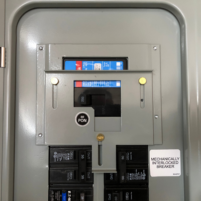 Mechanical interlock installed in electrical panel for portable generator